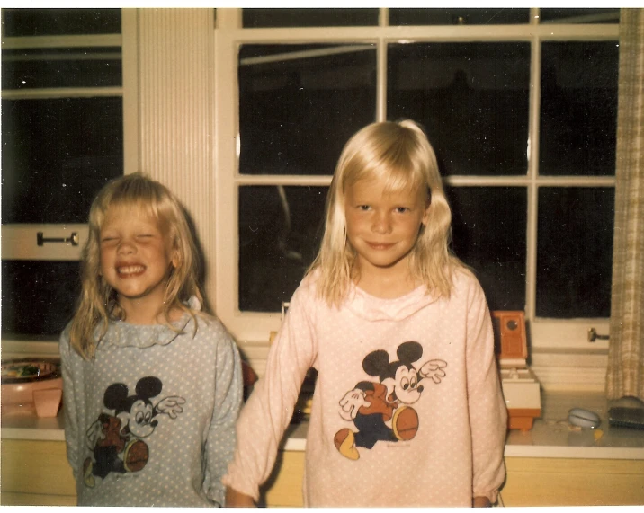 two little girls dressed in disney outfits with mickey mouse pajamas on
