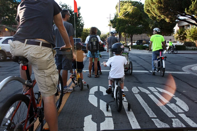 people are riding bikes on a city street