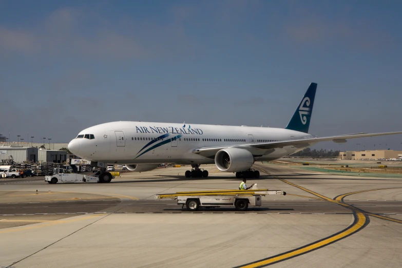 an airplane that is on the runway in front of the airport