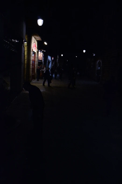 people walking on sidewalk with dark background