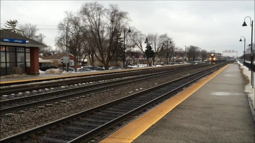 a train is at the train stop in the snow