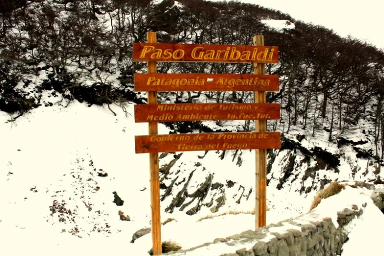 a sign for a trail in the snow