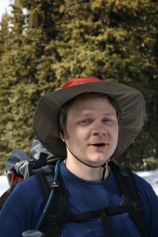 a young man wearing a brown hat on his back