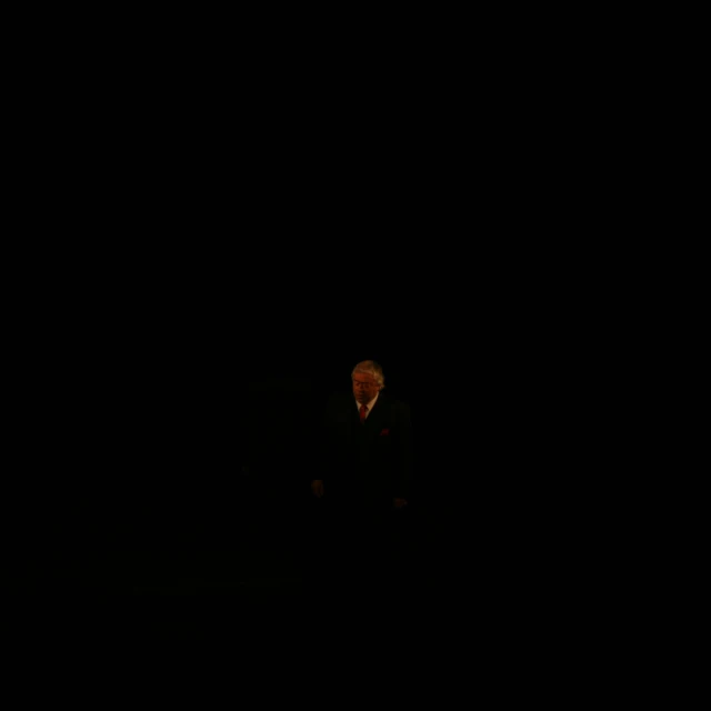a man sitting in the dark alone
