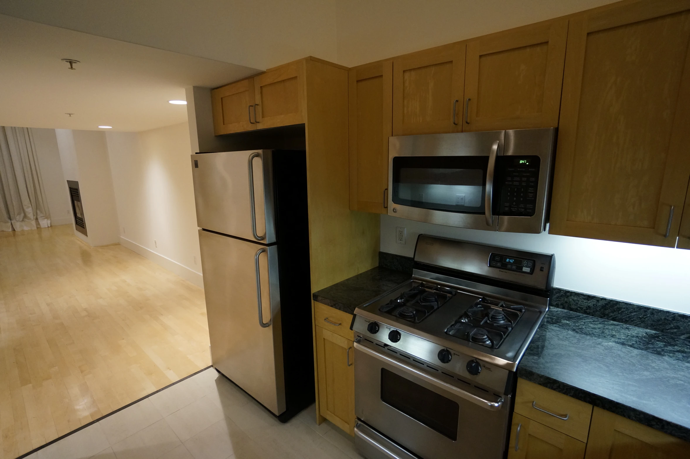 a kitchen with wooden cabinets and a refrigerator