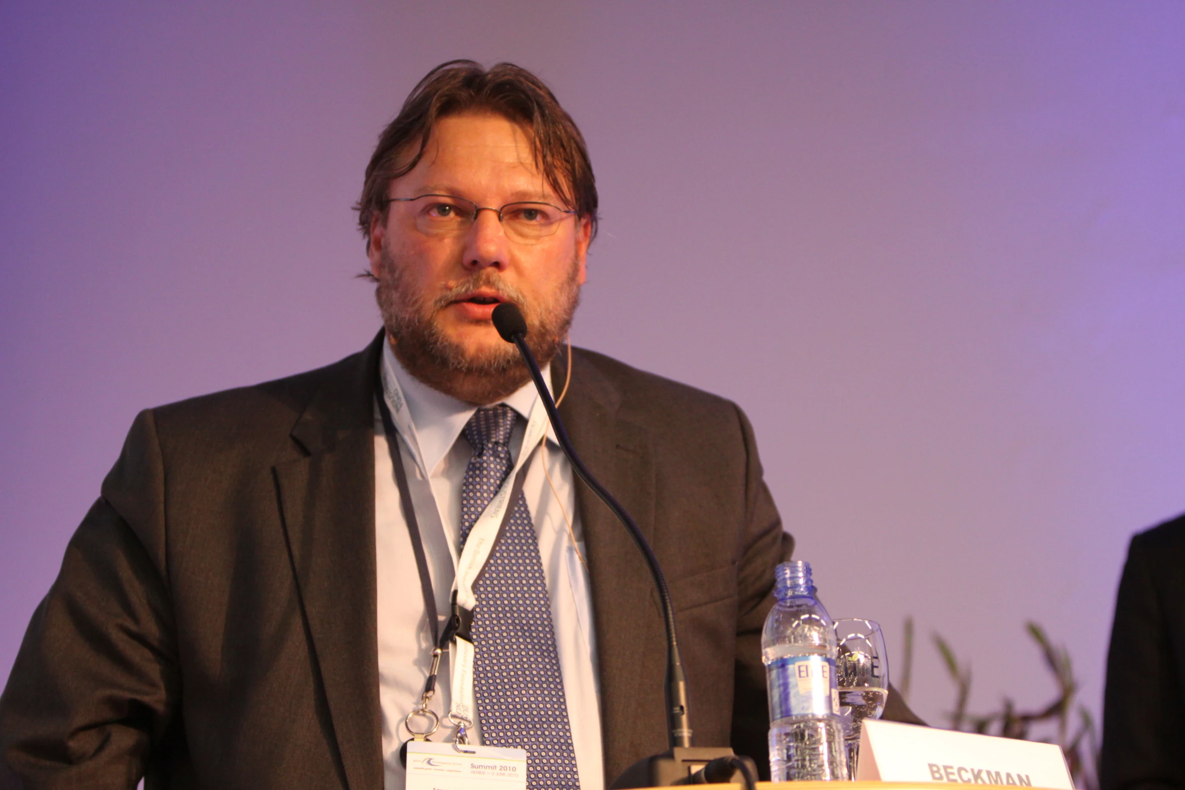 man talking at a podium with a microphone