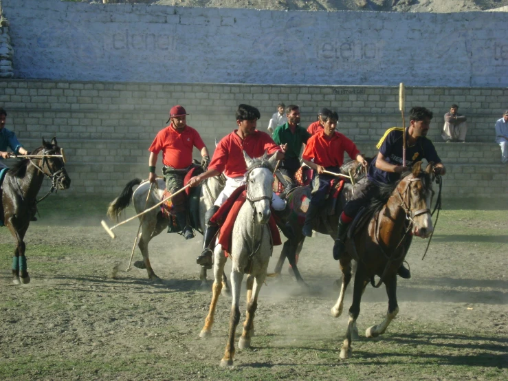 there is a polo match being played on horses