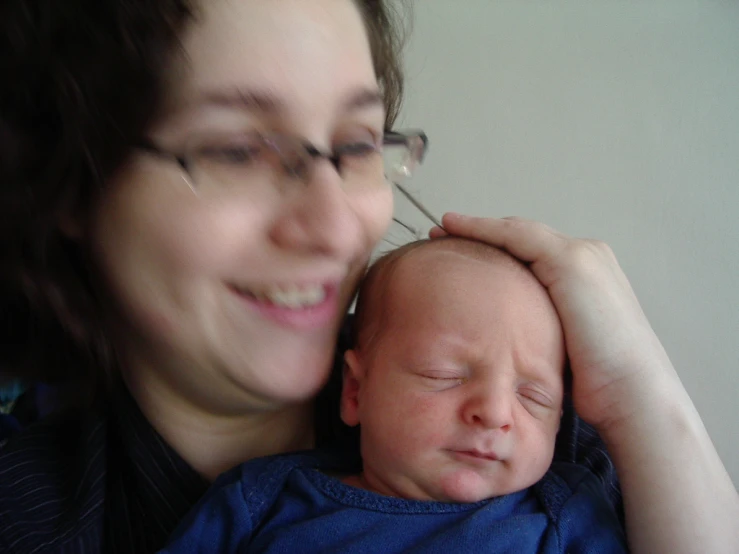 a smiling woman holding her infant girl