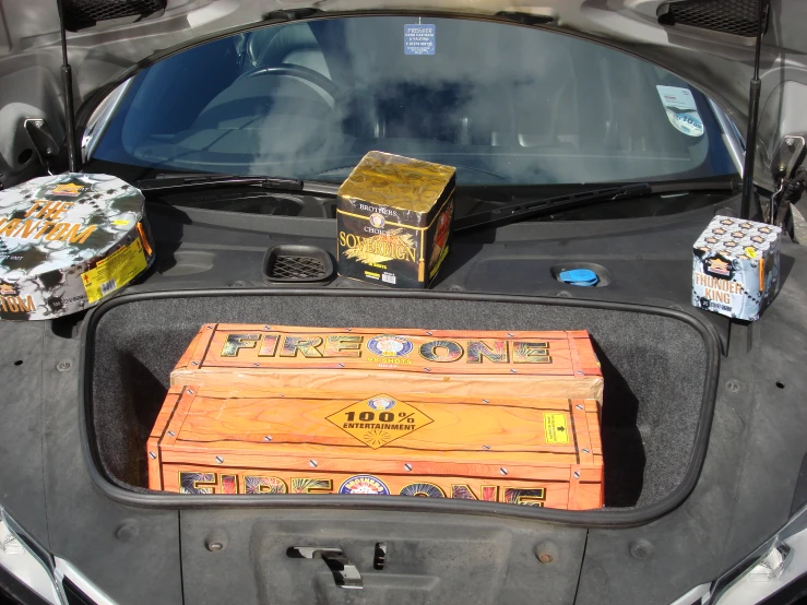 a trunk and box of beer in the back of a car