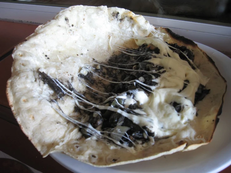 a whisk with chocolate chip topping is resting on a plate