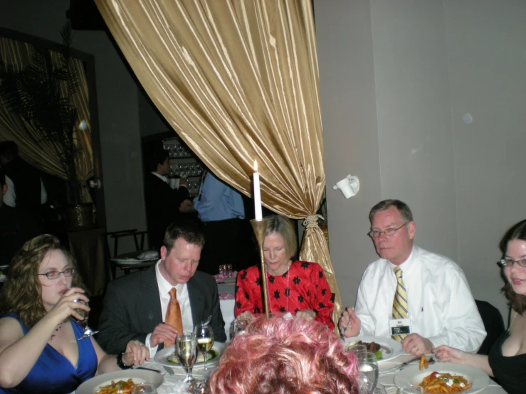 four people sitting at a table with wine glasses