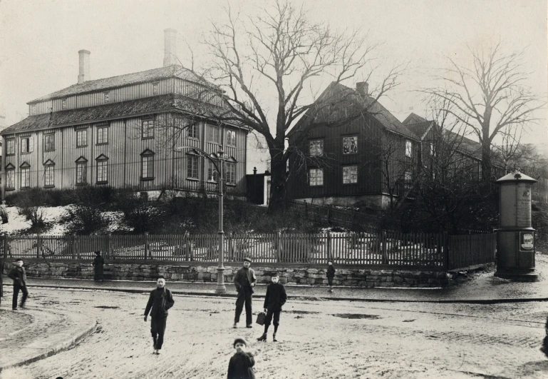 old black and white po with people walking on a street