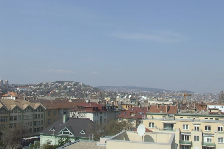 a city with lots of buildings next to some hills