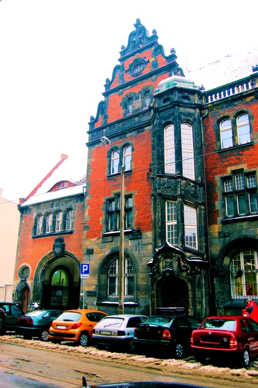 a red and black van parked in front of a building