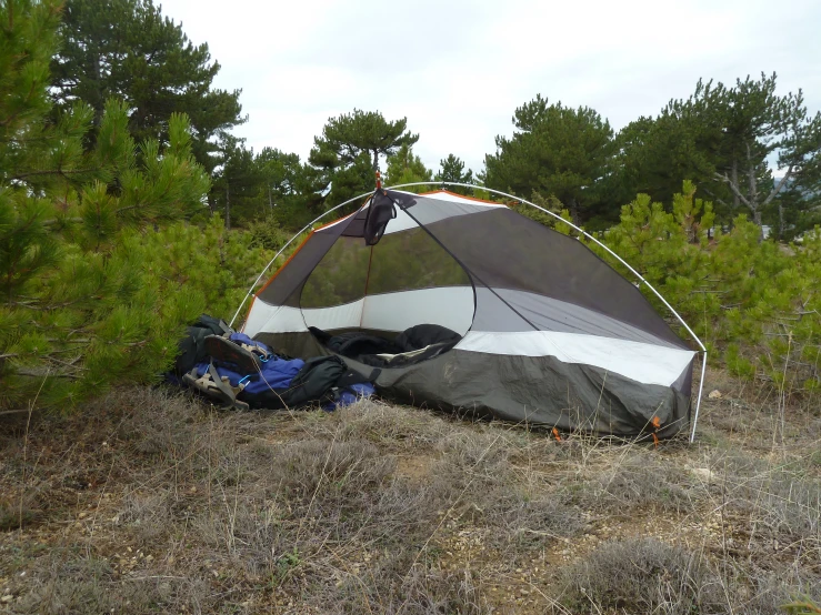 a large black and grey tent on the ground