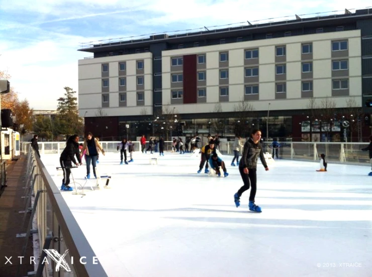 some people skating and having fun at an ice rink