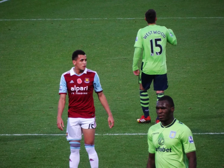 two men on soccer field talking to each other