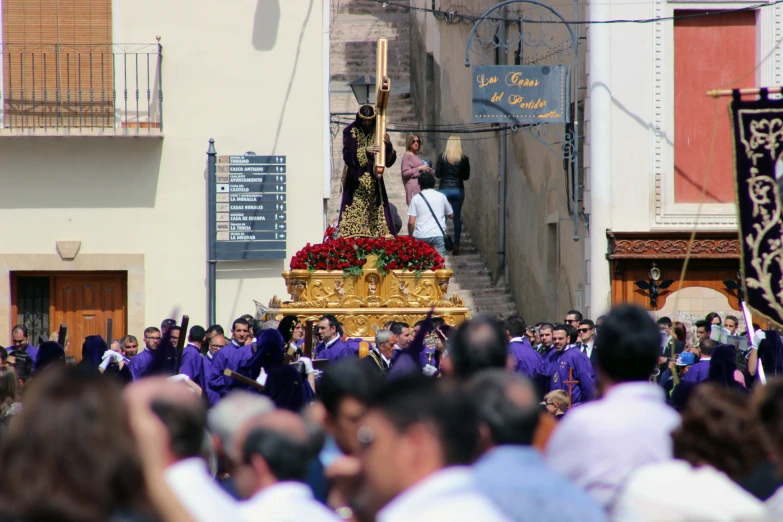 an altar being carried by a large group of people
