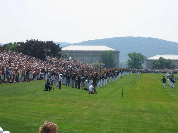 a large group of people in uniform at a sporting event