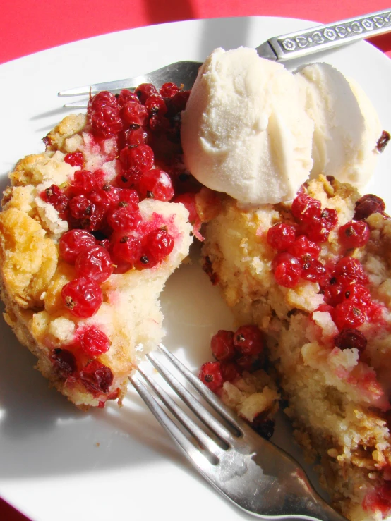 a white plate with some berries and a fork