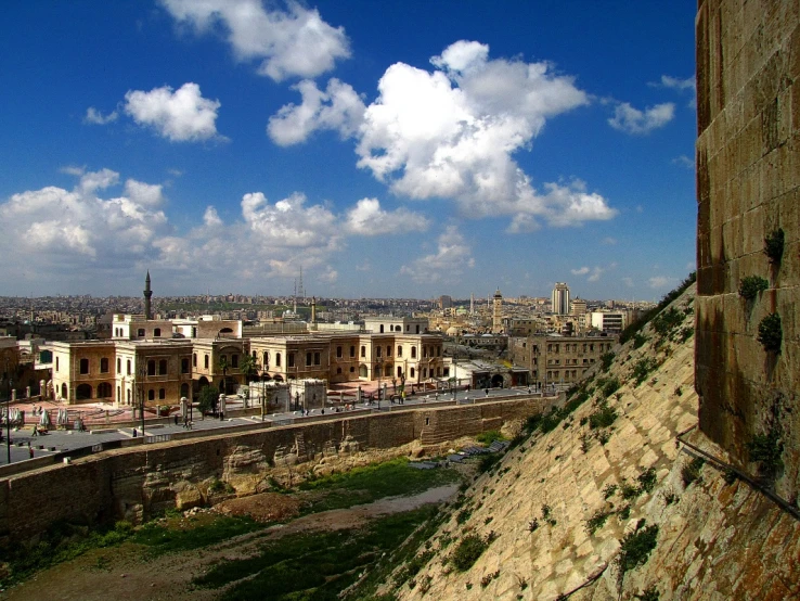 a street view with buildings and hills in the background