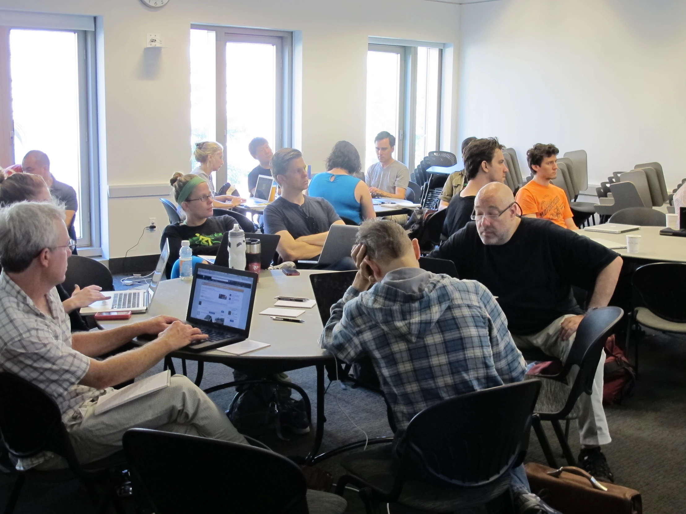 a group of people sitting in front of computers