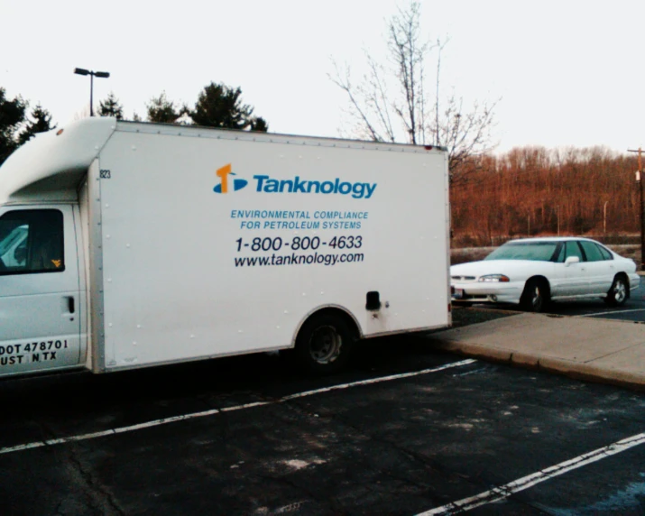 the large white truck is parked in the lot