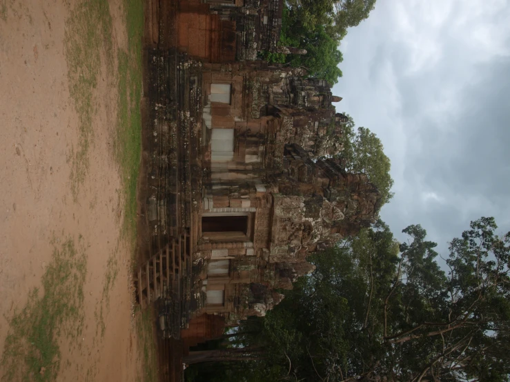 large, old stone structure with an entrance to a jungle