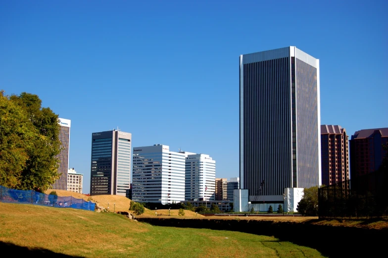 a city with buildings on the edge and some grass on the ground