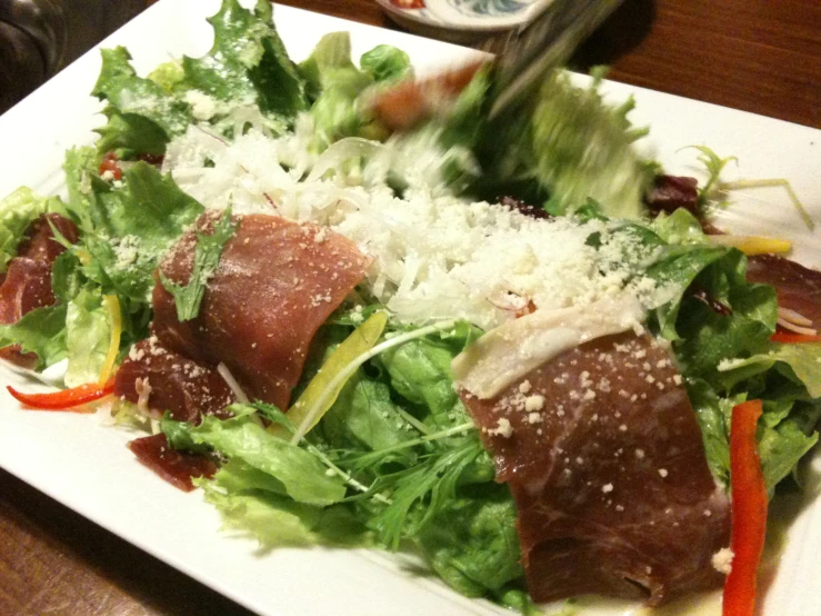 closeup of salad with meat and cheese on a plate