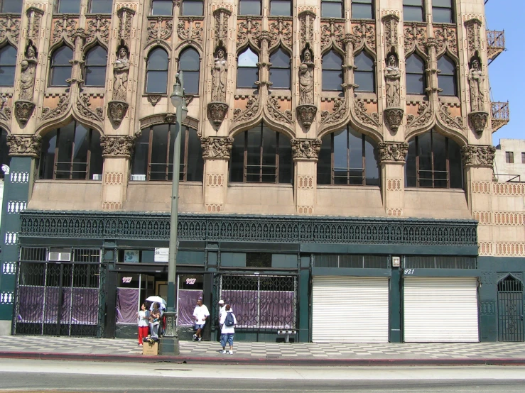 two people walking in front of an old fashion store