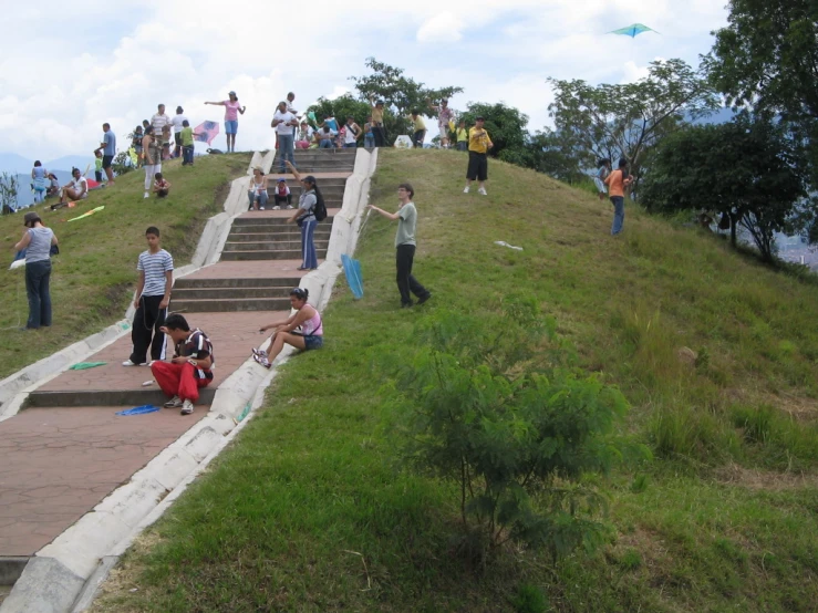 several people walking up some stairs with their backs to the ground