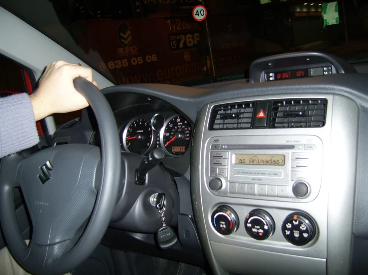 a woman driving a car with the dashboard and gauges on