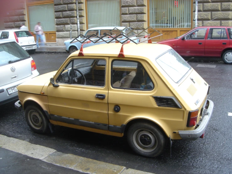 a car with a little box on the top of it's roof