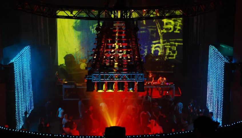 a colorful stage set up with lights on the top