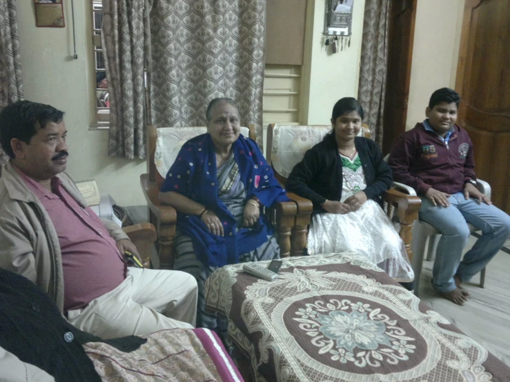 a group of people sit in a living room