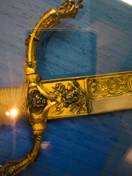 an elaborate gold handle on a display case