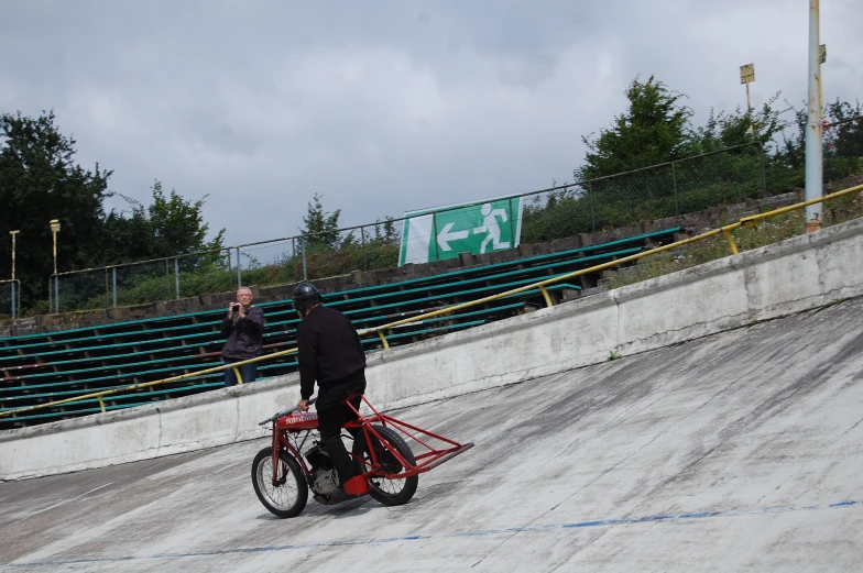 a man riding his bike around an empty track