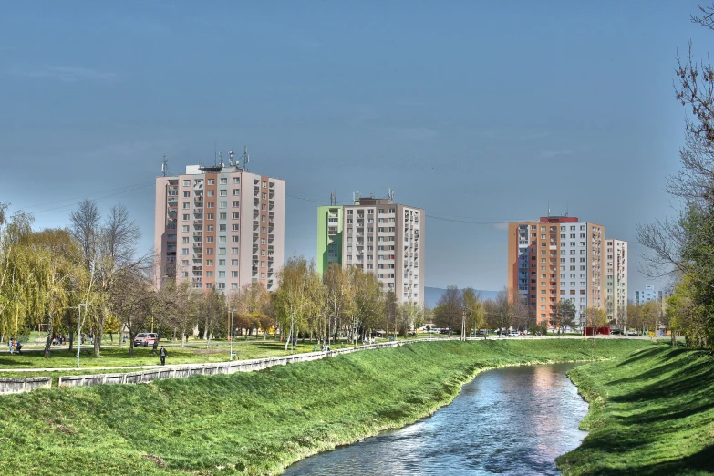 the city is covered in tall buildings on the other side of a river