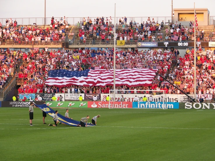 a soccer game with many people watching and fans