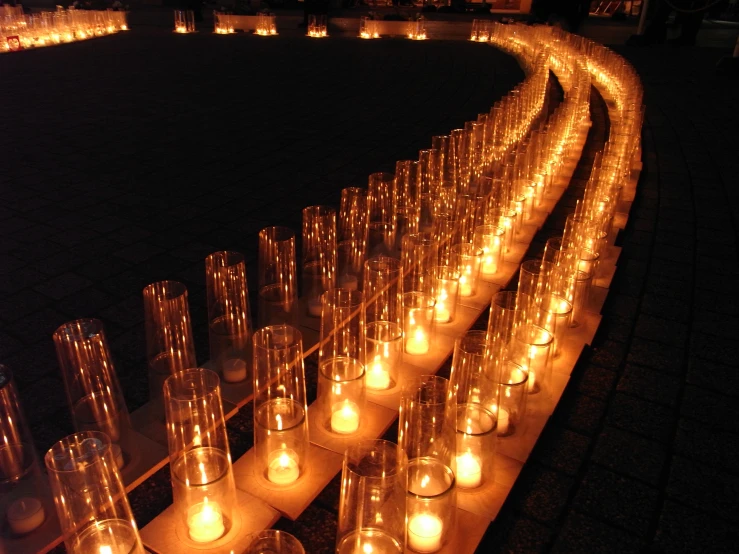 a large group of lighted candles on a long line