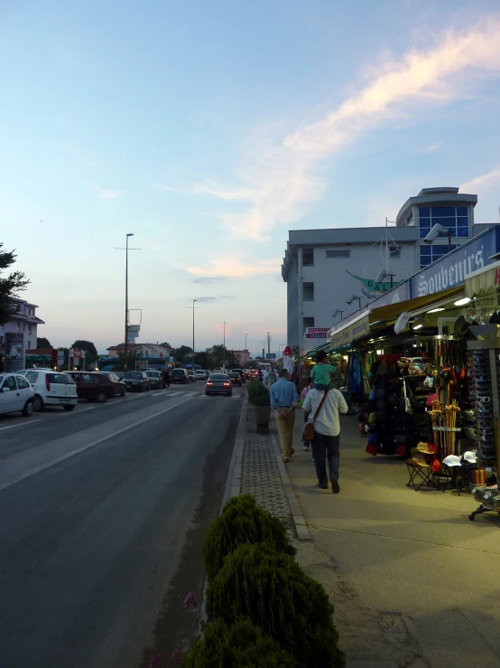 shops on the side of the road filled with people