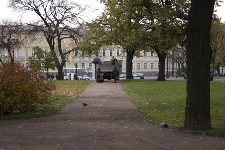 a park with people on the back and a bird walking along it