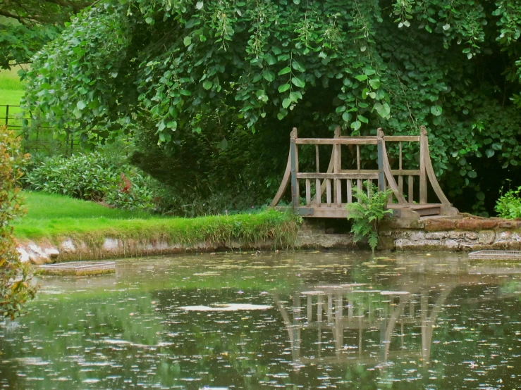 an image of a wooden bridge on the water