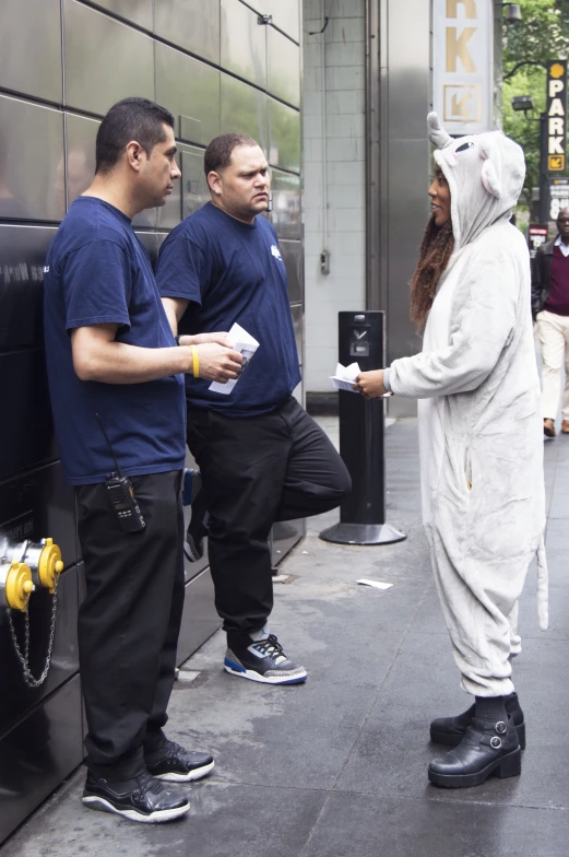 man in bunny costume interacting with two friends