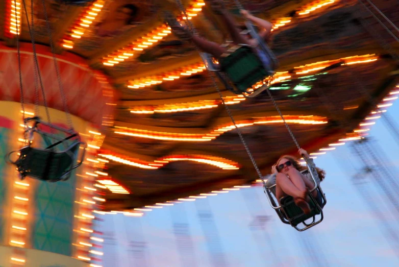 a po of two children riding on a merry go round