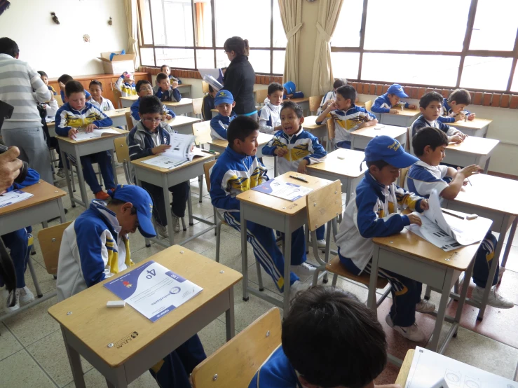 school children sit in their classroom and write