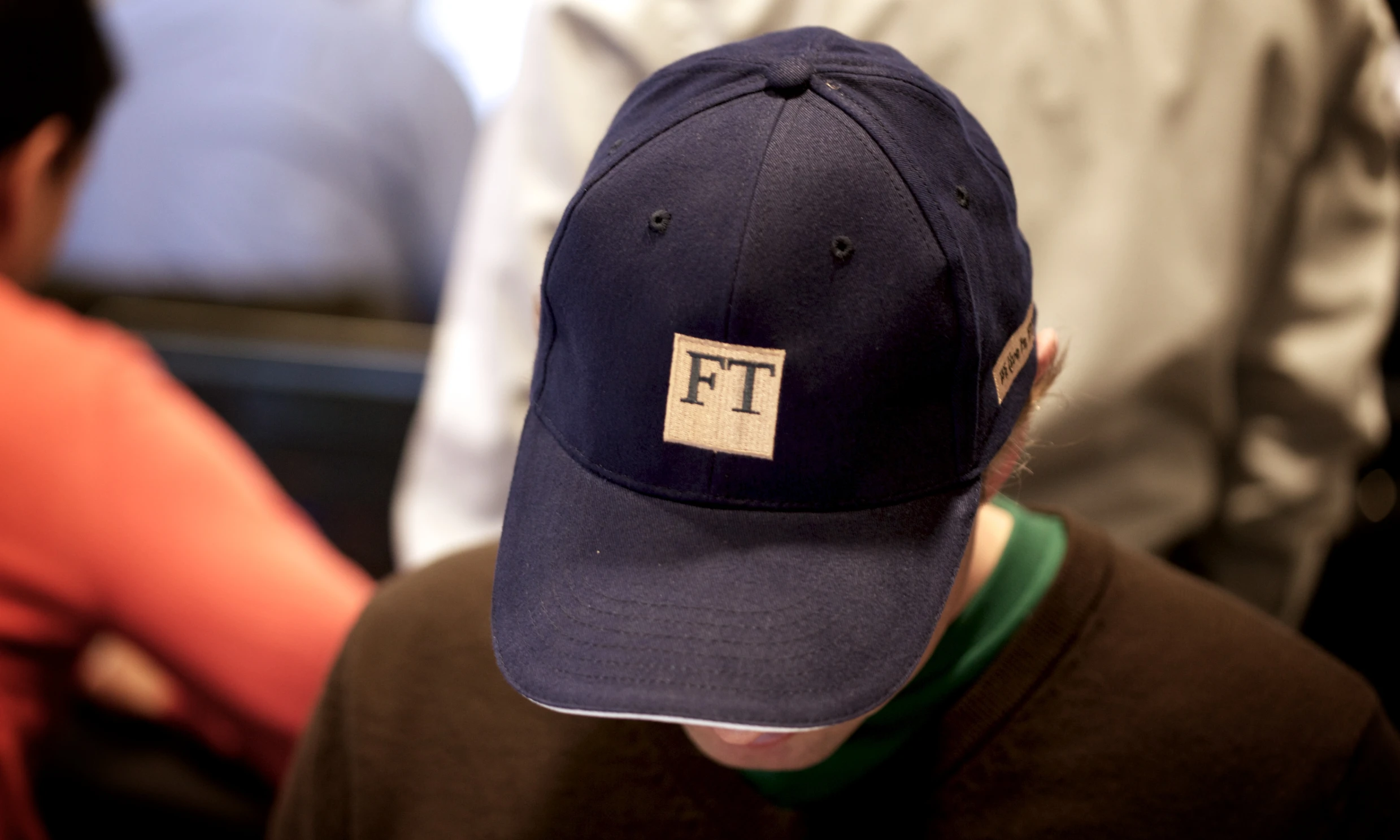 a boy in a hat at a table