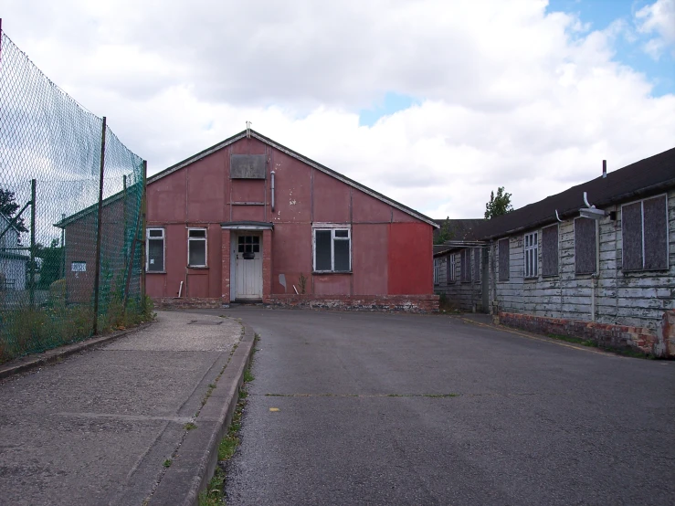 an empty parking lot with boarded windows and boarded doors