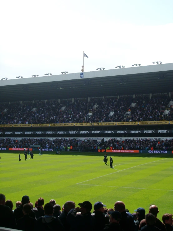 a large crowd of people watch a football match